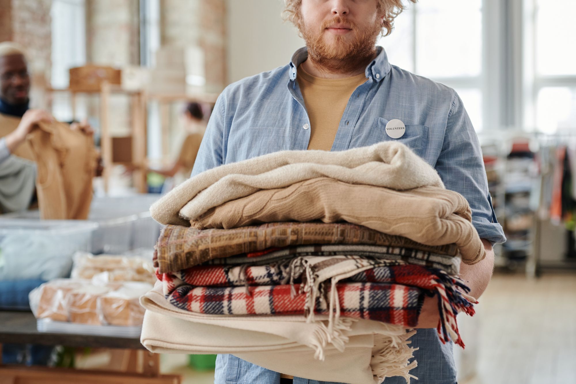 Folded blankets and warm clothing collected for a winter appeal.