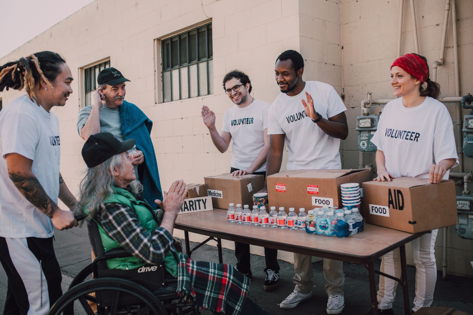 A group of community volunteers standing together outdoors, smiling.