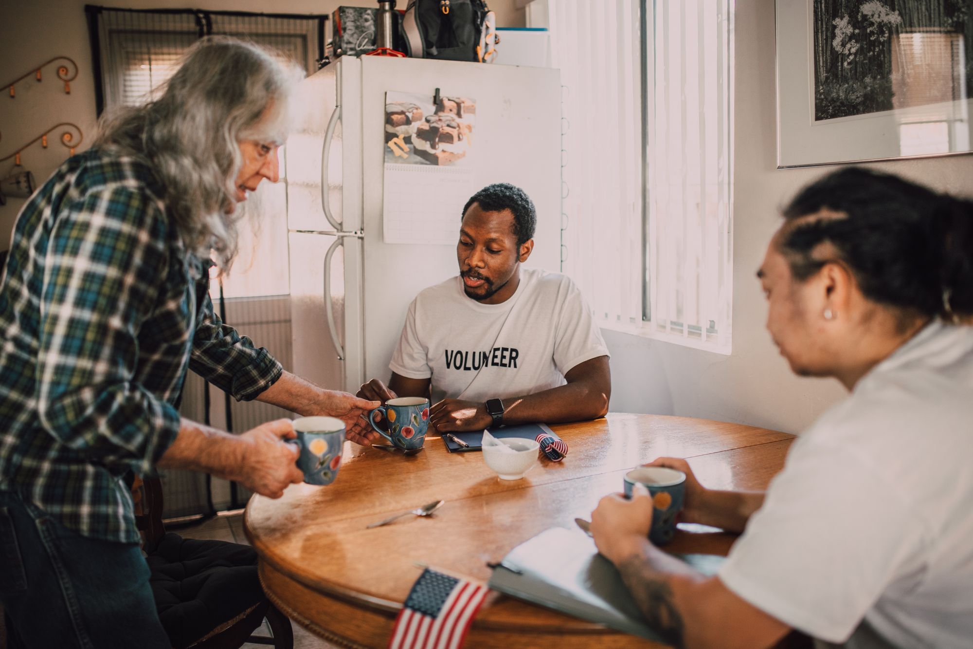 Volunteers gathered around a table, planning together.