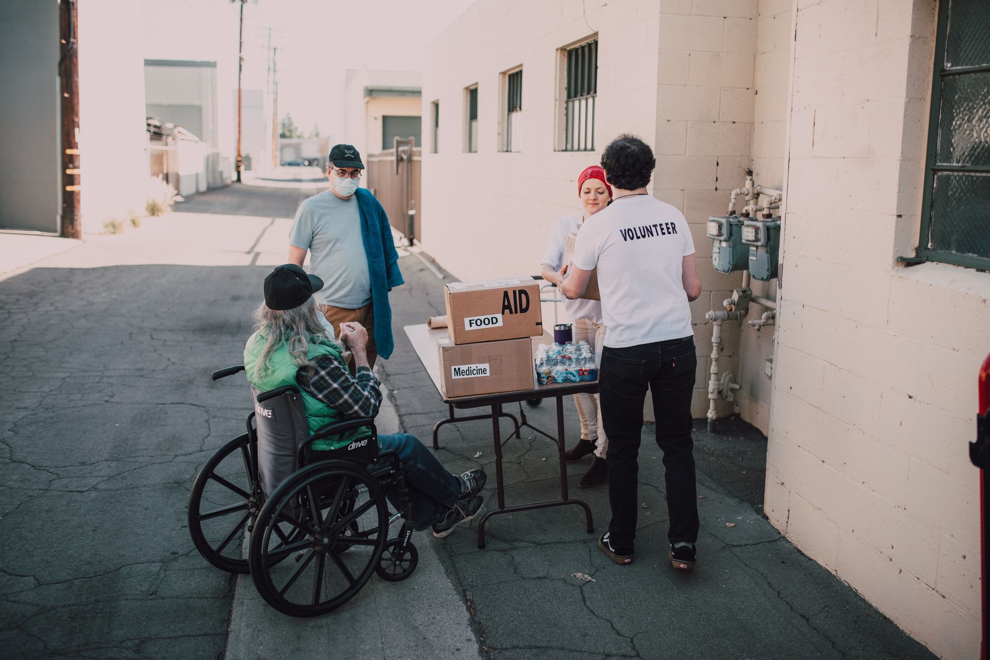 Volunteers organising parcels of food for distribution.